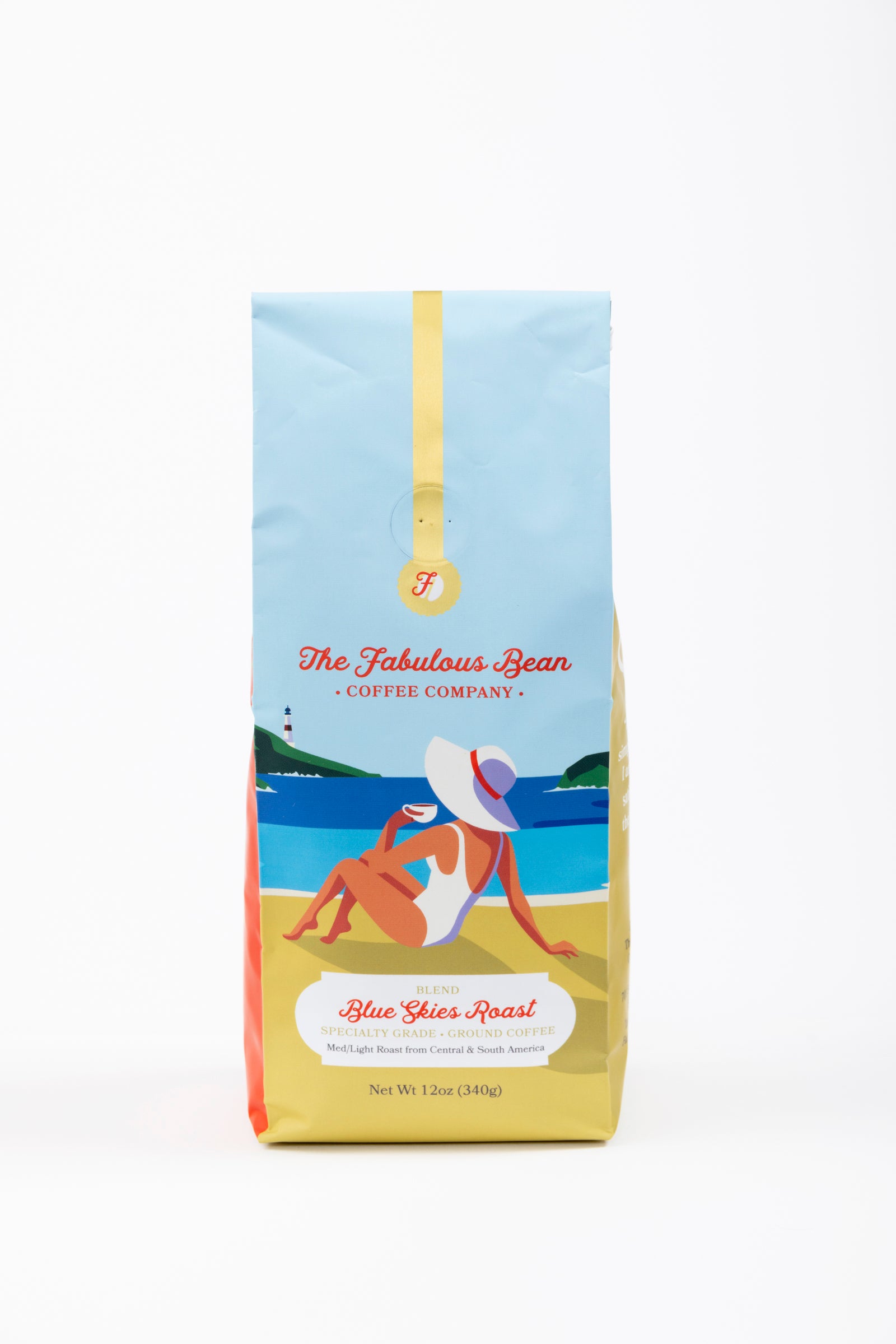 Specialty-grade medium light ground coffee blend from Central and South America in a colorful 12 ounce bag with the front panel depicting a sophisticated lady wearing a modest one piece bathing suit and floppy hat enjoying a cup of coffee while seated on a beautiful beach against a background of  light blue sky, green covered hills, an azure sea and golden sand. 