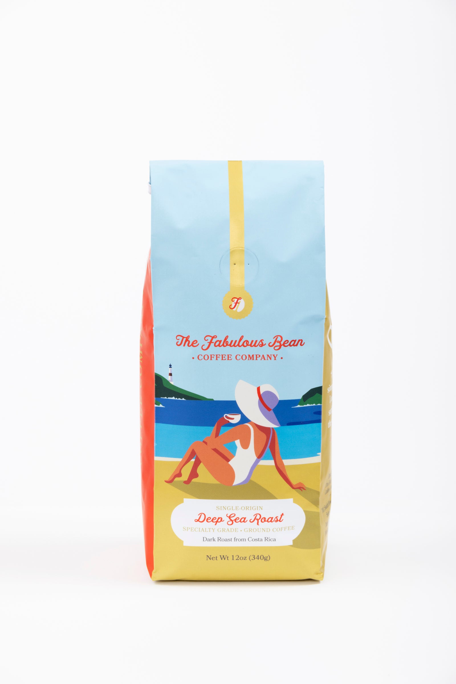 Specialty-grade dark roast ground coffee from Costa Rica in a colorful 12 ounce bag with the front panel depicting a sophisticated lady in a modest one piece bathing suit and floppy hat enjoying a cup of coffee on a beautiful beach against a background of  light blue sky, green covered hills, an azure sea and golden sand. 