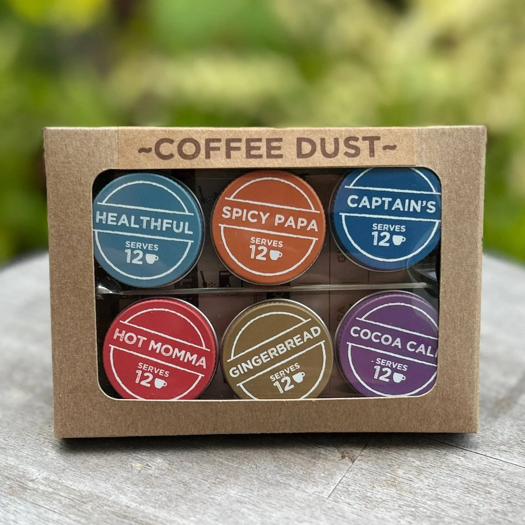 Expedition Kit of Vashon Island Coffee Dust with colorful labels of six flavors on a wooden surface.