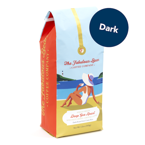 Fabulous Bean Coffee's Deep Sea Dark Ground Roast in a 12 ounce bag featuring a sophisticated woman enjoying coffee on a beautiful beach