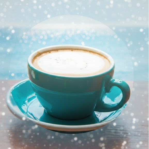 Freshly brewed coffee served in a teal colored cup and saucer.