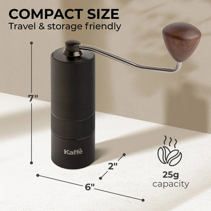 Black color manual coffee grinder by Kaffè with metal grinding arm and wooden handle. Dimensions and capacity details are provided. The grinder is 7" high and has a 2" diameter. Its capacity is 25 grams, which will brew 12 to 16 ounces of coffee, depending on strength desired. 