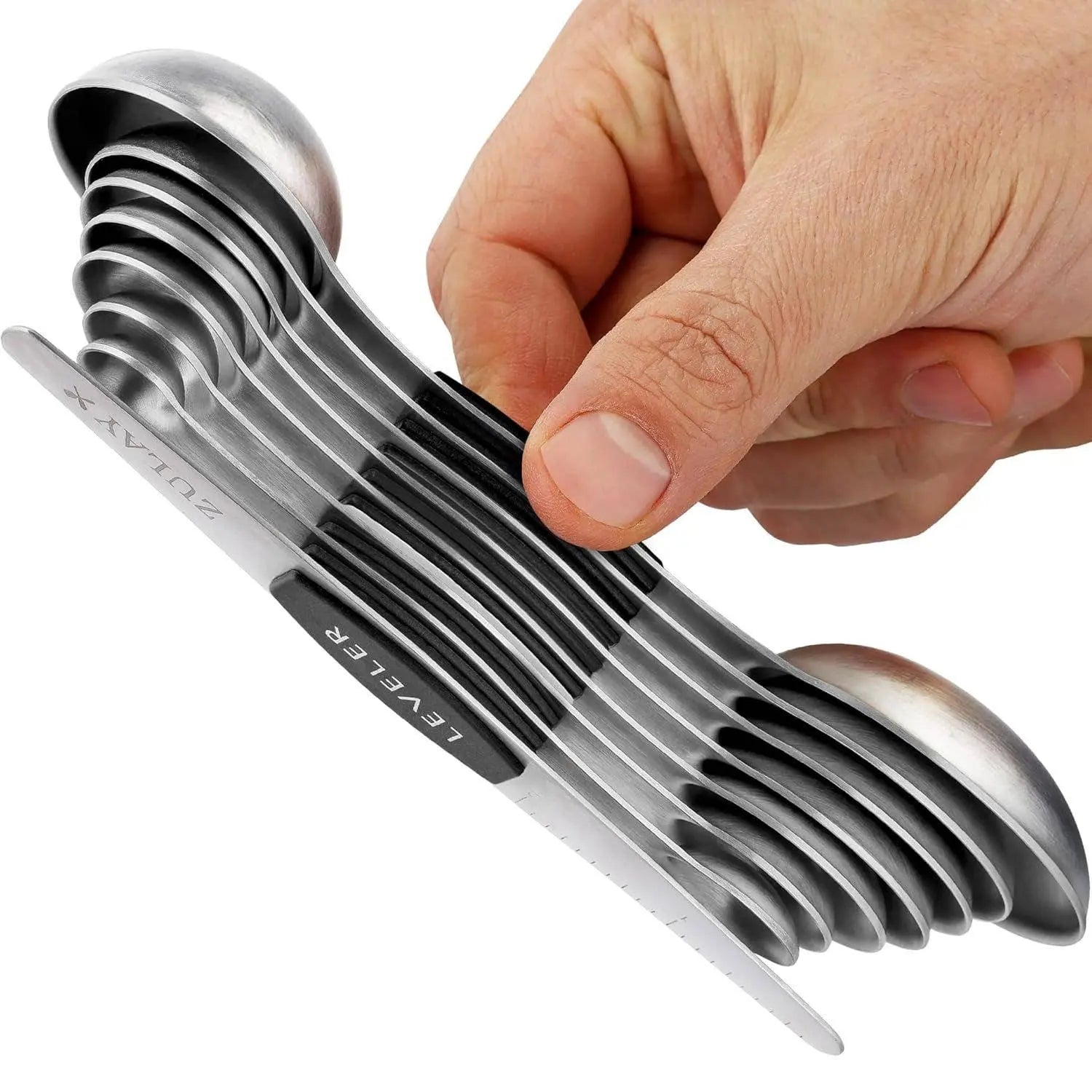 Set of Zulay magnetic measuring spoons in stainless steel held by a hand over a white background.