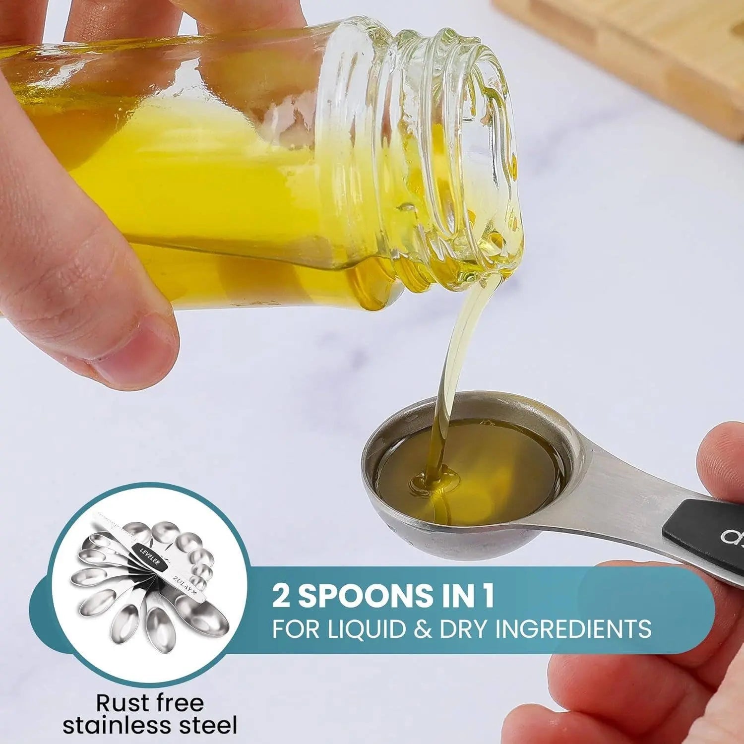 Hand pouring liquid from a jar into a Zulay stainless steel measuring spoon. 
