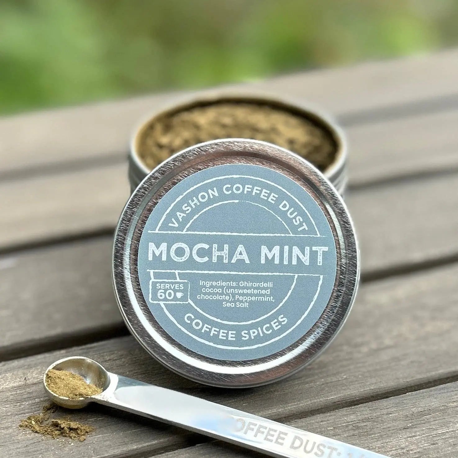 Mocha Mint coffee dust container with a measuring spoon on a wooden surface