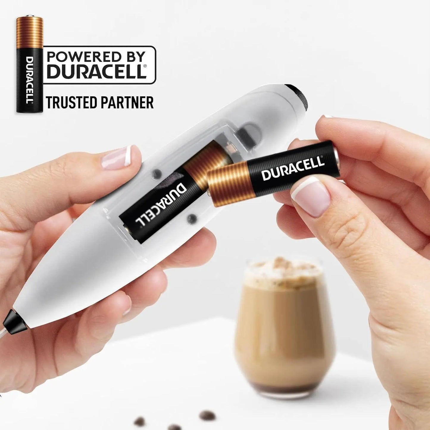 Duracell AA battery being inserted into a Zulay Tornado Milk Frother.